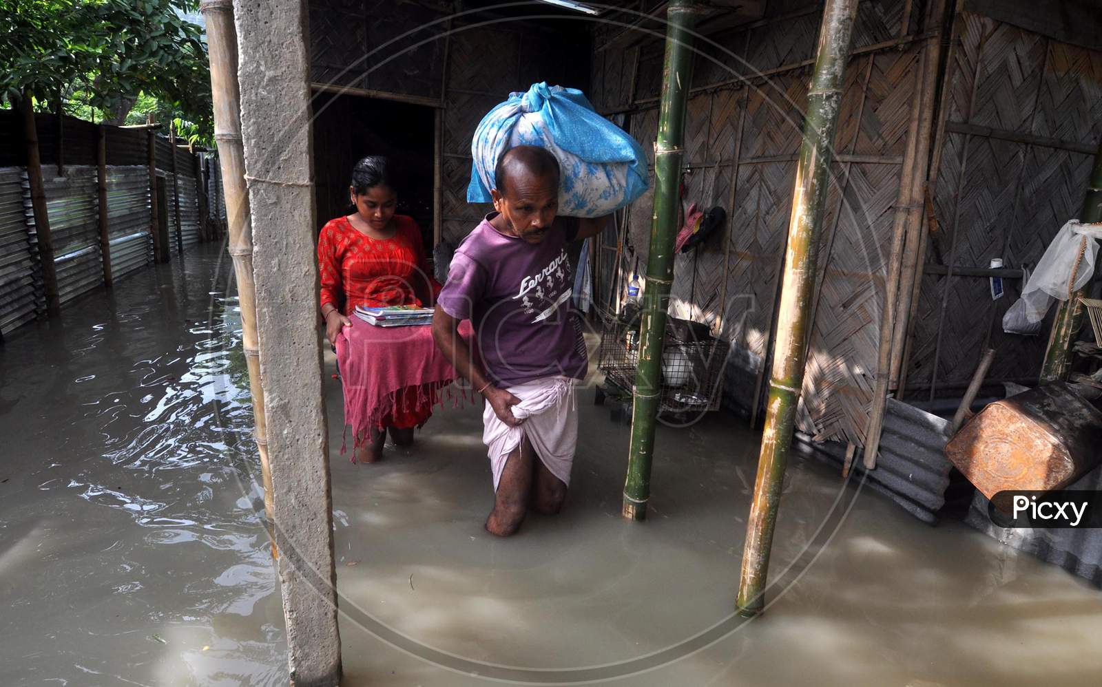 Villagers move to a safer place from the flood-affected areas in Hatisela district in Kamrup, Assam on July 14, 2020