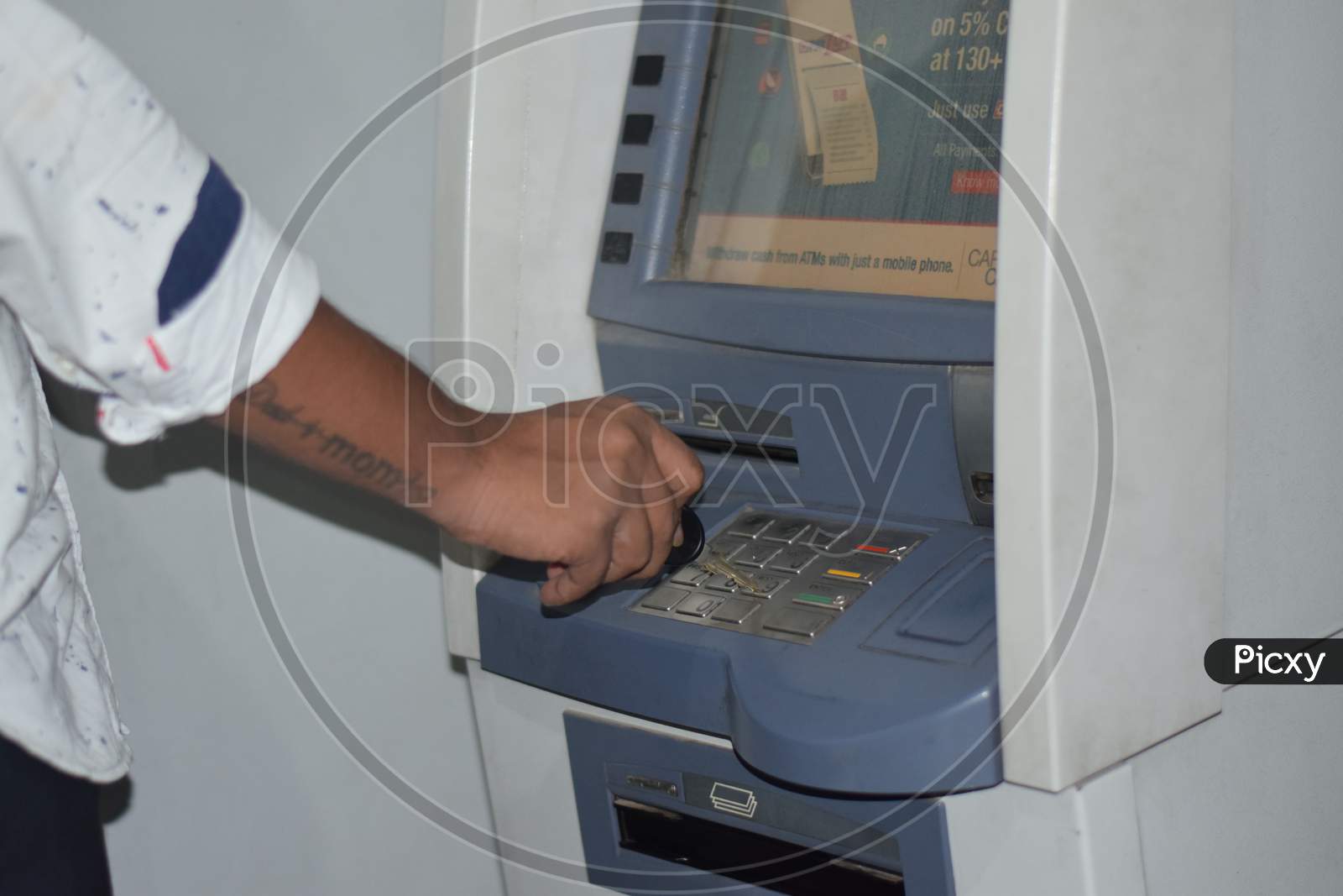 Man Using Atm Machine To Withdraw His Money. Closeup Of Hand Entering Pin Or Pass Code On Atm Machine Keypad,Security Code On Automated Teller Machine, Close Up Of Hand Entering Pin At An Atm.