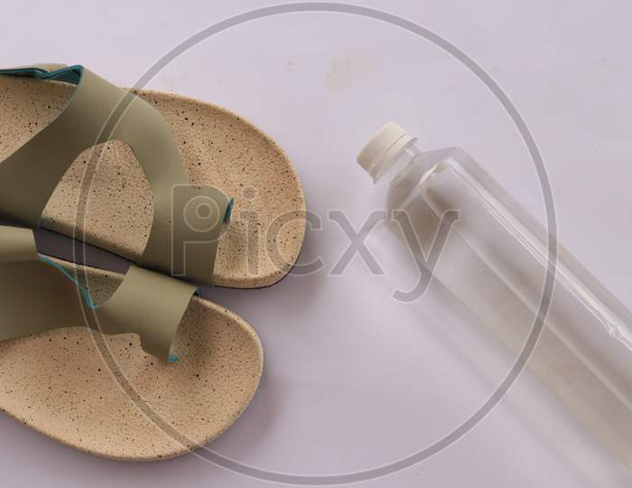 Slippers or Sandals with Water Bottle on White Background