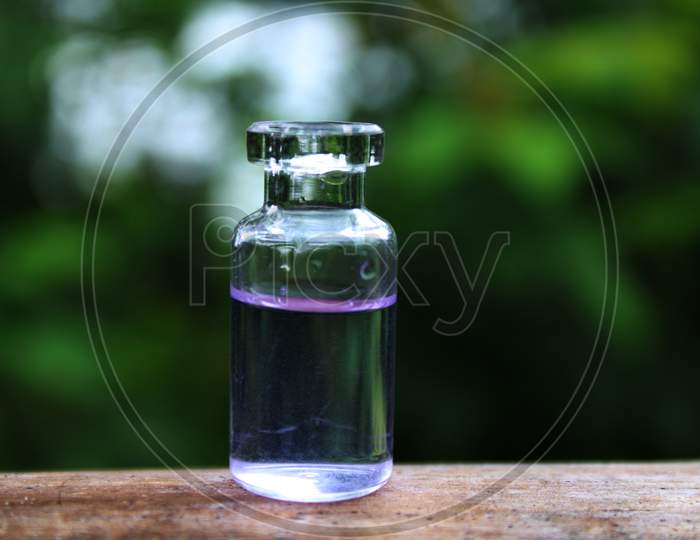 Water in the small bottle with natural background