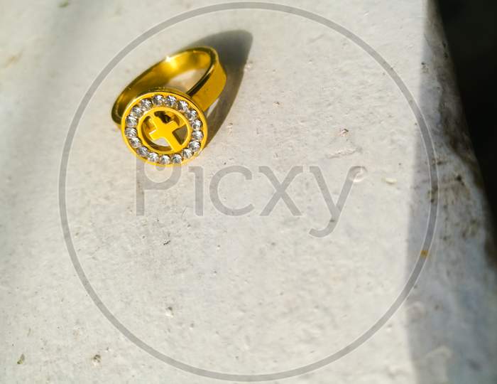 A golden ring placed on a white background