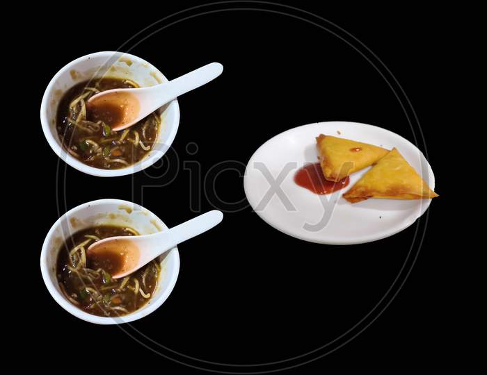 Two Bowls Of Noodles And Samosa Isolated On Black Background