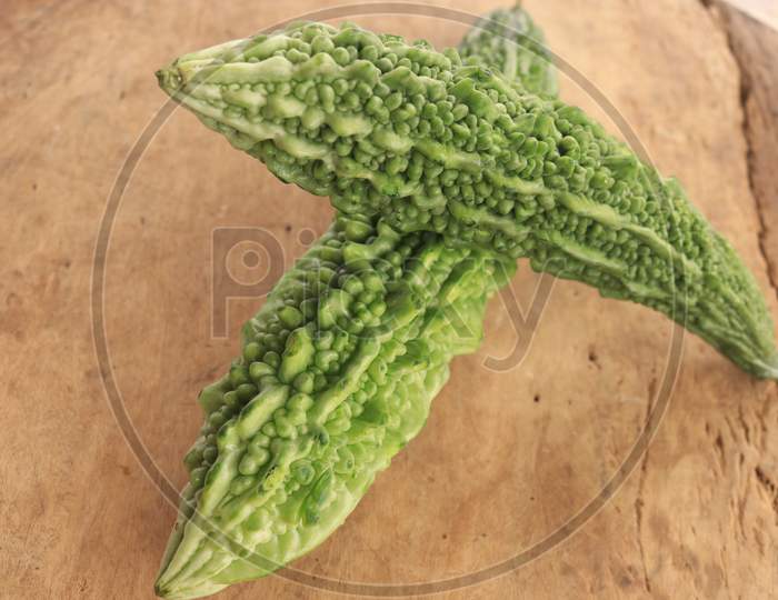 Bitter Gourd Vegetables isolated with Wooden Background