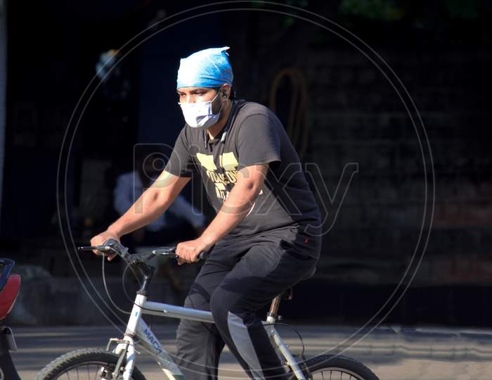 Hyderabad, Telangana, India. June-29-2020: Man With Protective Safety Mask On His Face Riding A Bicycle, Protective Mask Against Corona Virus