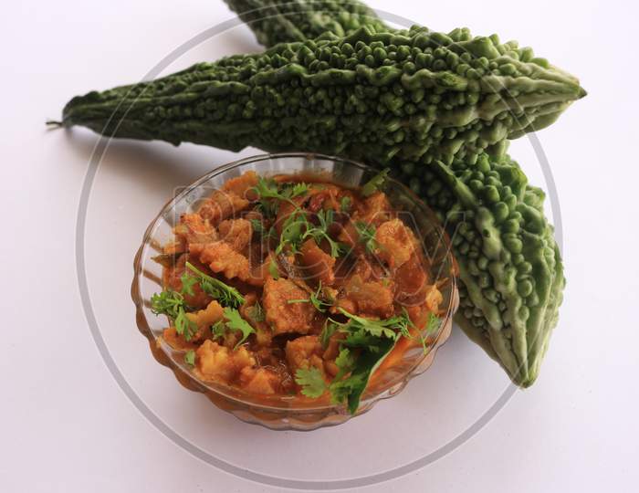 Bitter Gourd Curry in a Bowl with Bitter Gourd Vegetables isolated with White Background