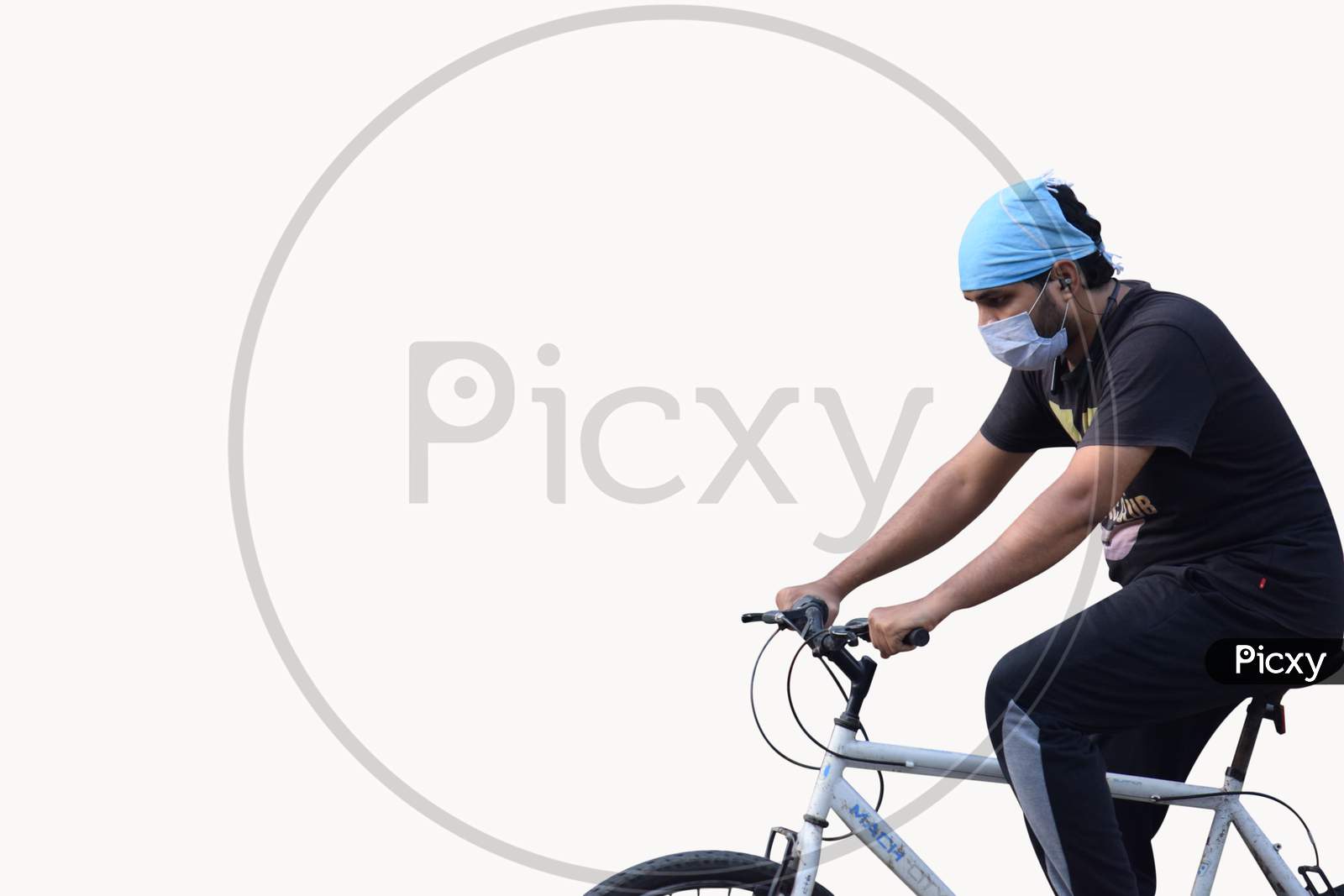 Hyderabad, Telangana, India. June-29-2020: Man With Protective Safety Mask On His Face Riding A Bicycle, Isolated On White Background