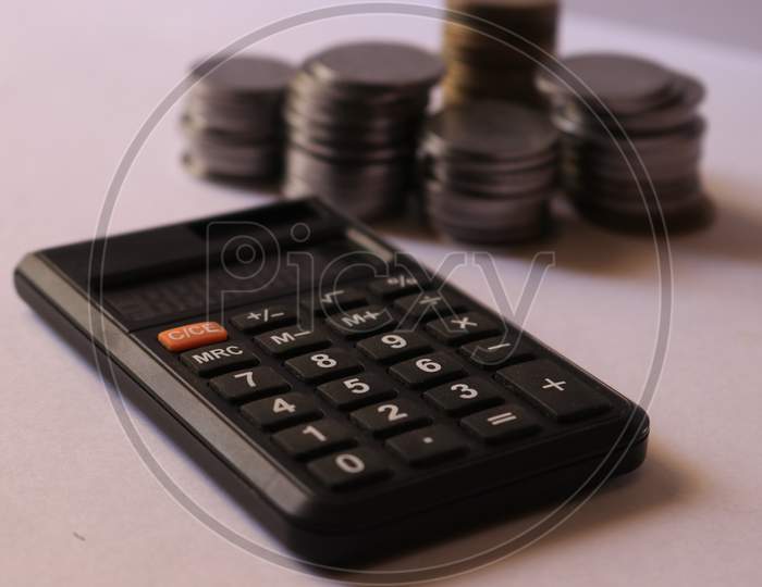 Indian Currency Coins with Calculator isolated with White Background