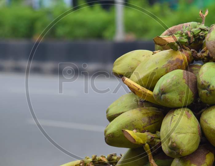 pile or bunch of coconuts on the cart at road for sells in india, hyderabad