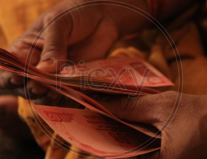 Close up shot of a Person Counting Indian Currency Notes