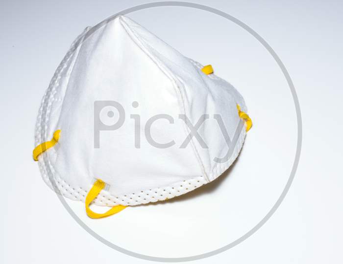 Isolated Face Mask For Use In Covid 19 Pandemic. Placed On A White Surface Side View