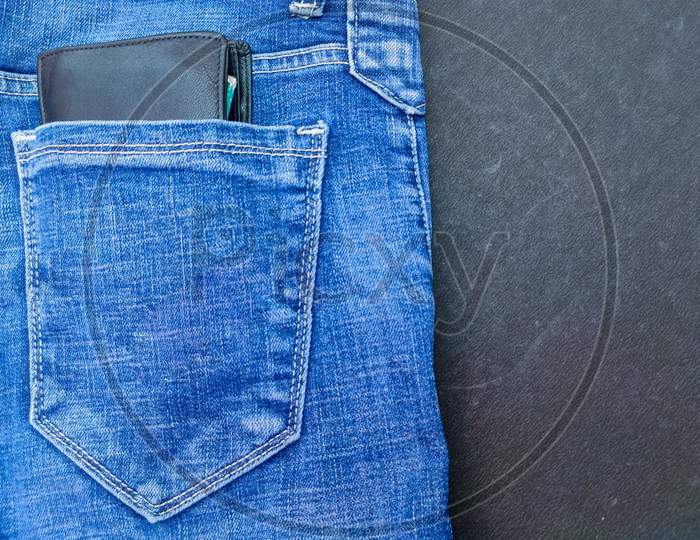 Black man purse in blue jeans back side pocket
