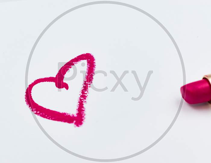 Pink Heart Sign Drawn With A Lipstick Isolated On White Background