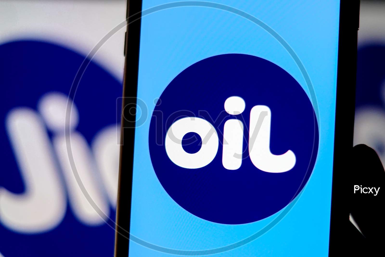 Flipped Jio Logo as OIL in a Smartphone with Jio Logo in the Background