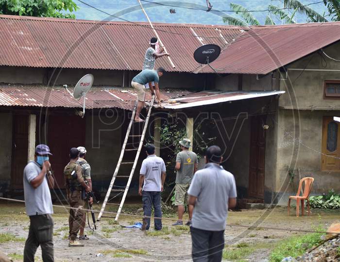 Forest officials try to rescue a  tigress that strayed into a house in Nagaon, Assam on July 15, 2020