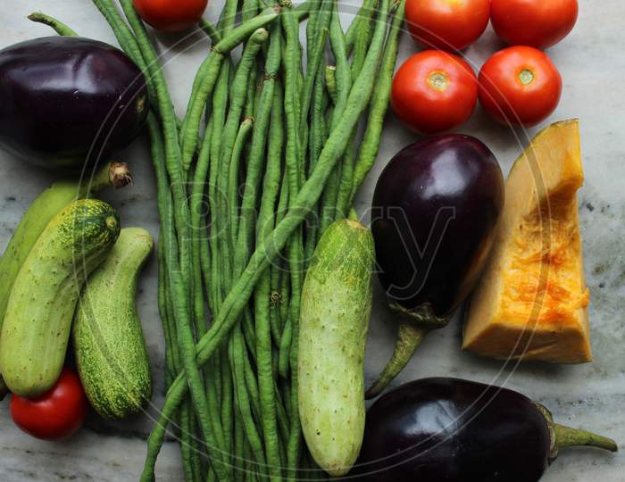 Green beans display with selective focus and fresh various raw organic vegetables for healthy and diet background.