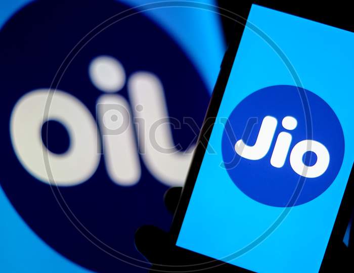 Jio Logo in a Smartphone with Flipped Jio Logo as OIL in the Background