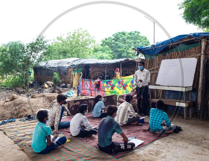 Satyendra Pal, a Delhi teacher delivers classes to students who don't have access to attend online classes in Yamuna Khadar, New Delhi on July 06, 2020