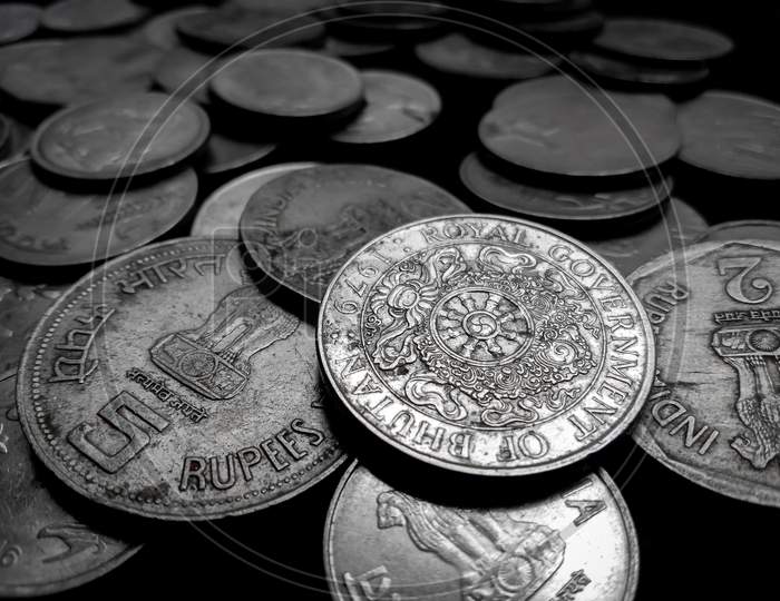 lots of coins image in black background with selective blur