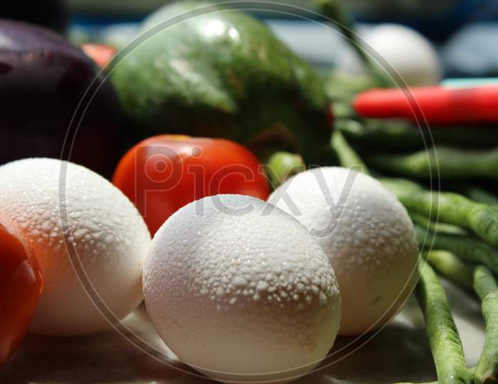 Eggs and fresh various raw organic vegetables display with selective focus