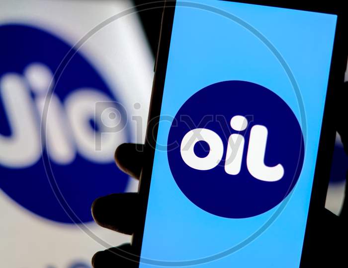 A Flipped Jio Logo as OIL on a Smartphone Screen with Jio Logo in the Background