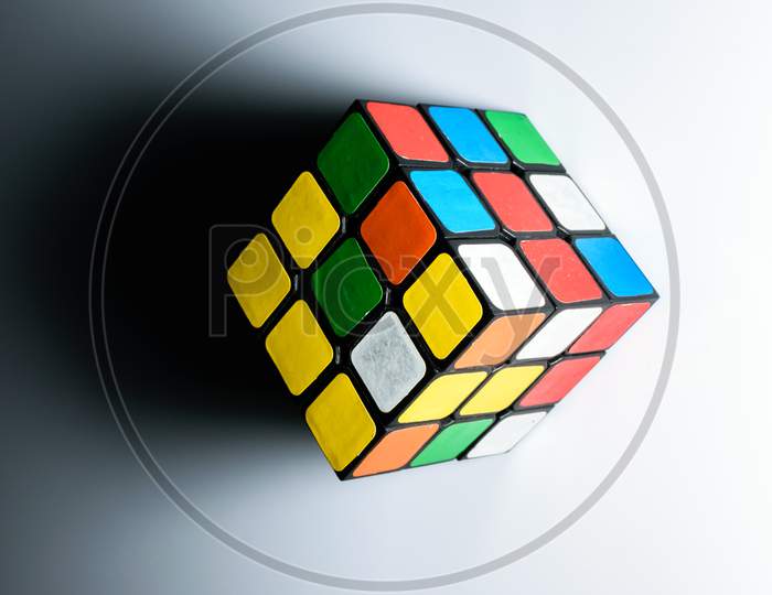 Isolated Rubik'S Cube With Its Shadow. White Background