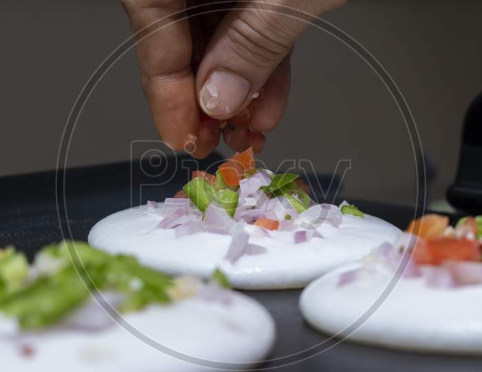 Adding Toppings O Sliced Vegetables On South Indian Dish