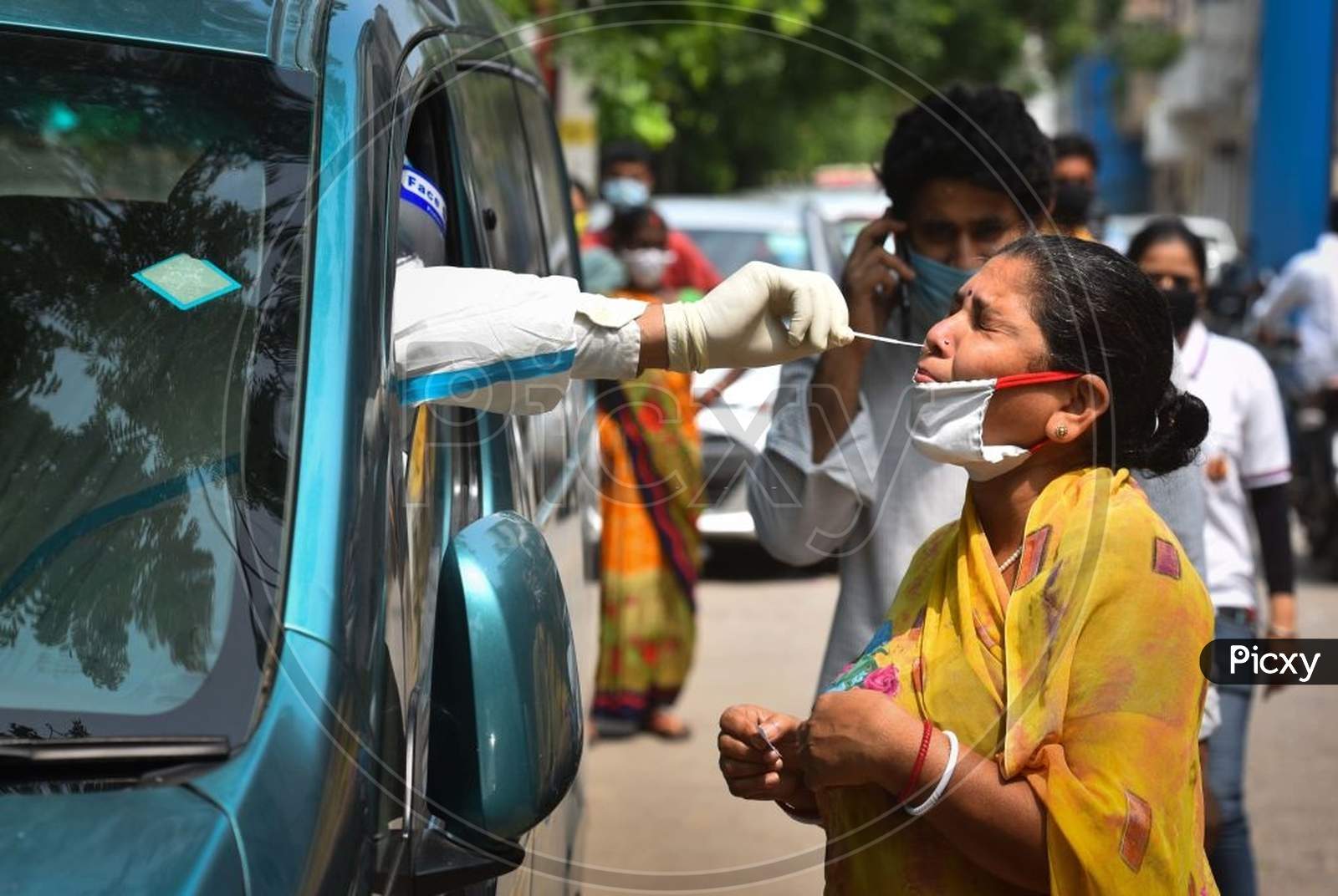 New Delhi, India - July 15: A Health Worker Of Special Mobile Surveillance Team In Ppe Coveralls Collects A Swab Sample From A Woman For Covid-19 Rapid Antigen Test, At Model Town, On July 15, 2020 In New Delhi, India. (Photo By Sanchit Khanna/Hindustan Times Via Getty Images)