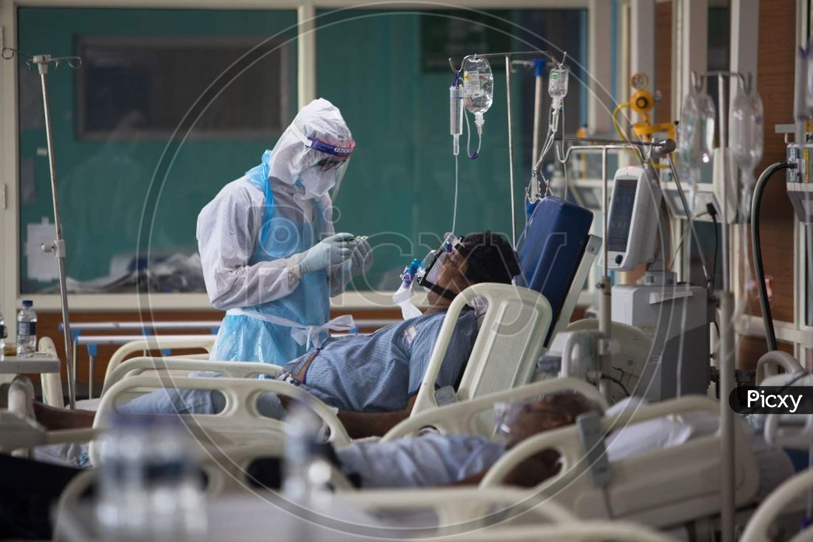 A Medical Staff Wearing Personal Protective Equipment (Ppe) Suit Looks After A Covid-19 Coronavirus Patient At The Intensive Care Unit Of The Sharda Hospital, In Greater Noida On July 15, 2020