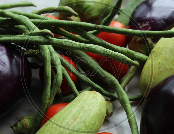 Green beans display with selective focus and fresh various raw organic vegetables for healthy and diet background.