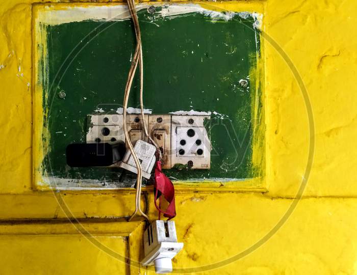 Yellow Painted Wall with Green SwitchBoard.