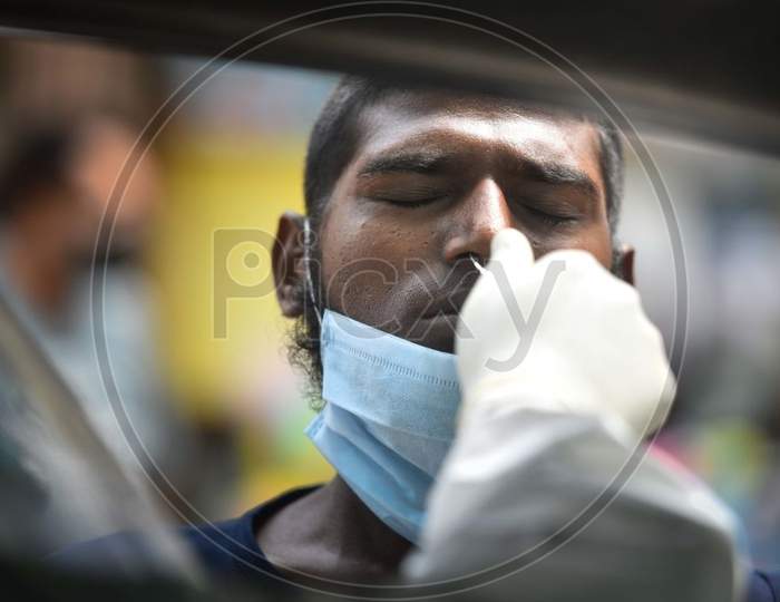 New Delhi, India - July 15: A Health Worker Of Special Mobile Surveillance Team In Ppe Coveralls Collects A Swab Sample From A Man For Covid-19 Rapid Antigen Test, At Model Town, On July 15, 2020 In New Delhi, India