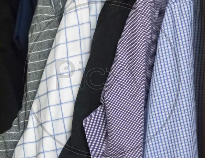 Mix Of Men'S Shirts Hanged In Wardrobe