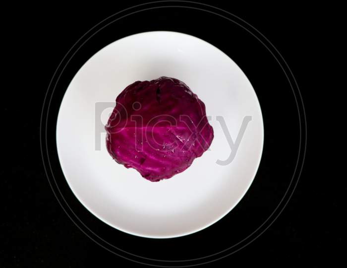 Fresh Raw And Organic Violet Color Cabbage In White Plate