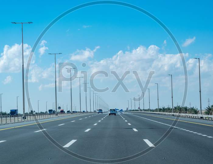 A Beautiful View Of Higway In Abu Dhabi With Blue Cloudy Sky