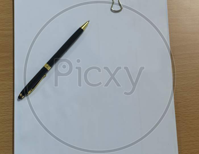 A Blank Letter Pad With Pen On A Table