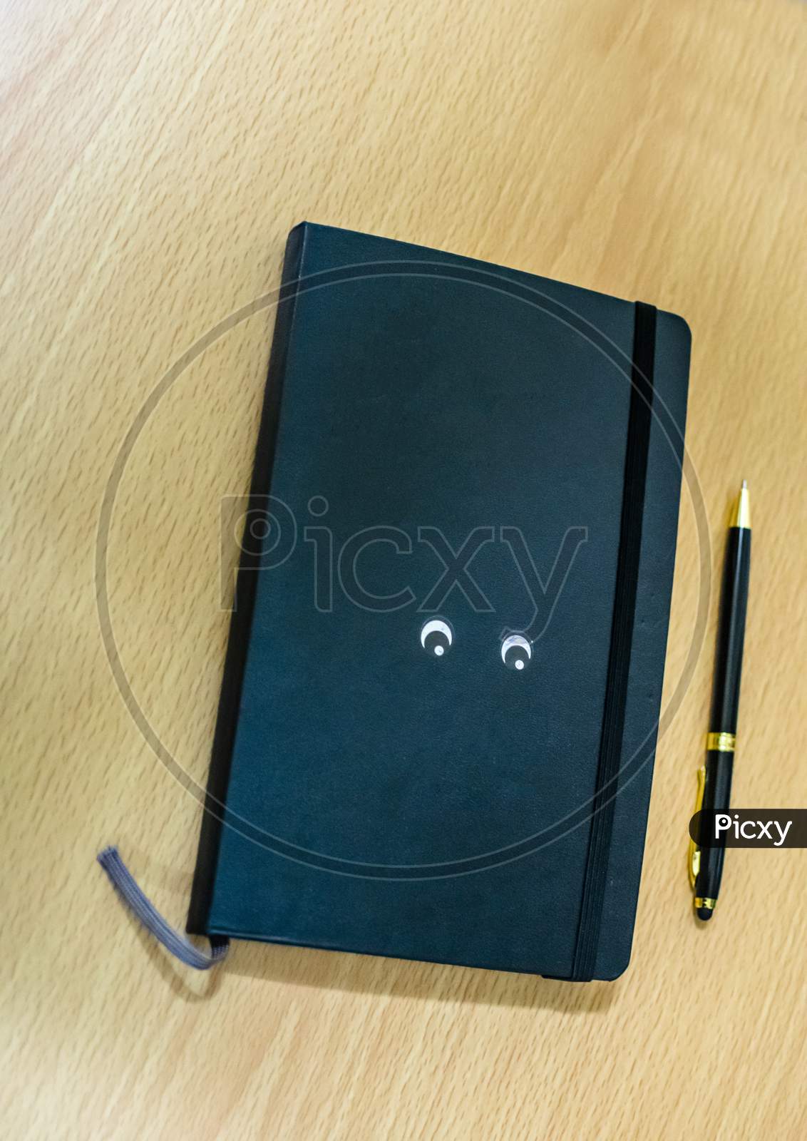 A Pen And Diary Book On A Table