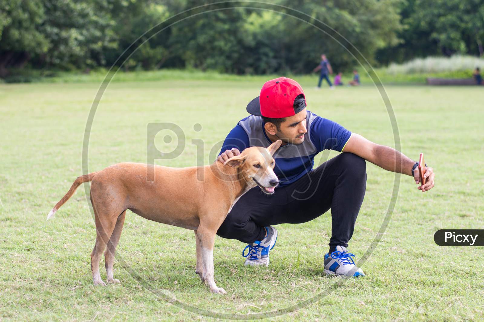 Young sports man taking selfie with dog in park, Animal lover and healthy sportsman concept.