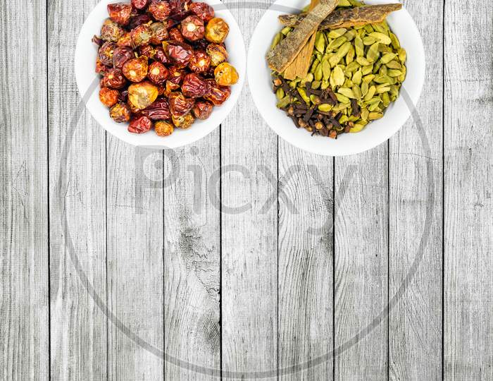 Round Red Chillies And Spices In White Bowls In A Nice Wooden Background