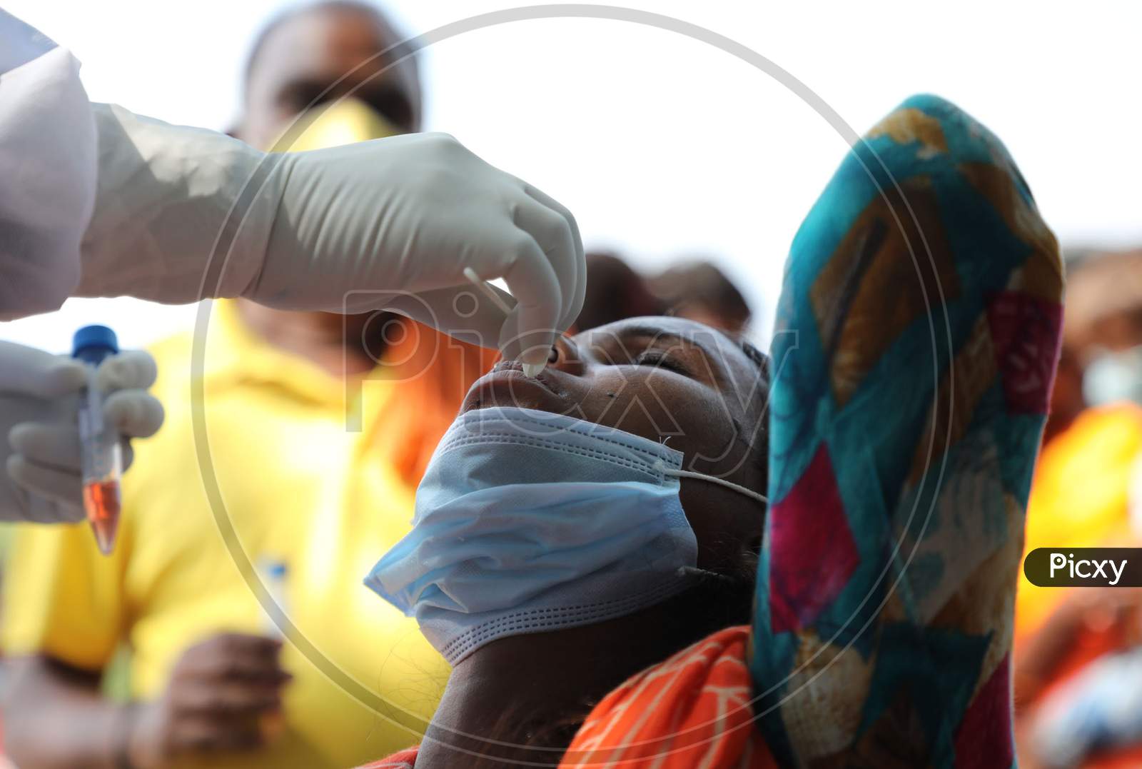 A health worker collects a swab sample from a child for Covid-19 testing in Maratha Basti, Jammu on July 16, 2020