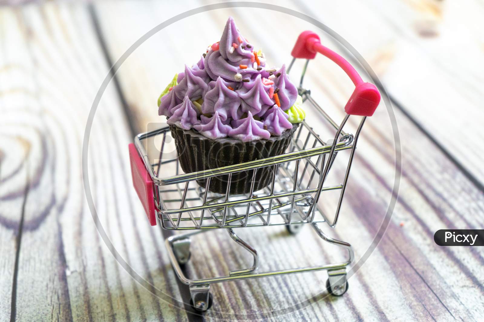 Beautiful Cupcake Dessert Sweet Soap Placed In A Shopping Cart On A Wooden Background