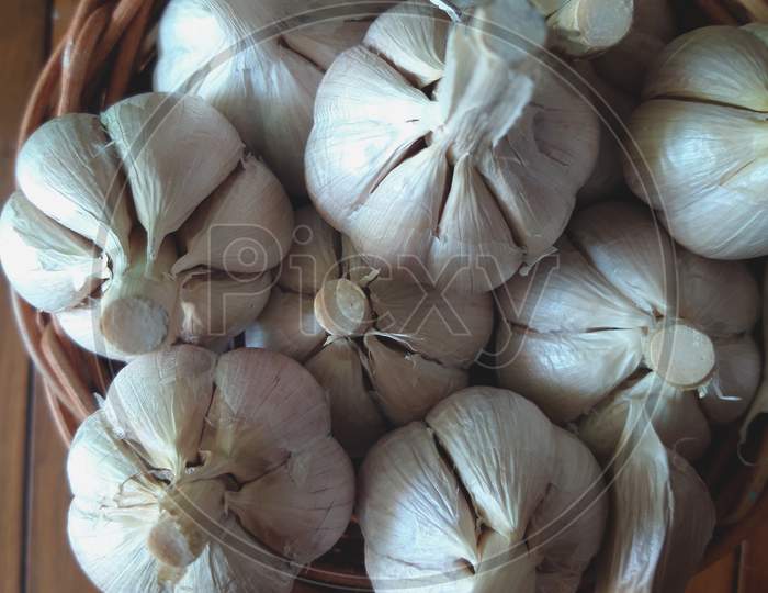 high angle view of garlic in a basket as a condiment