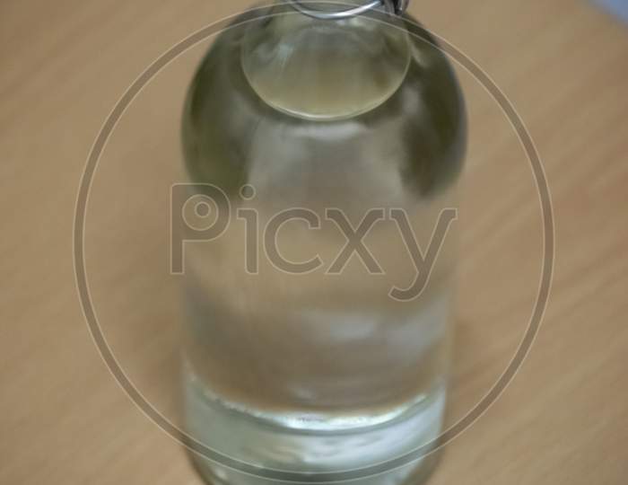A Glass Bottle Filled With Water On A Table