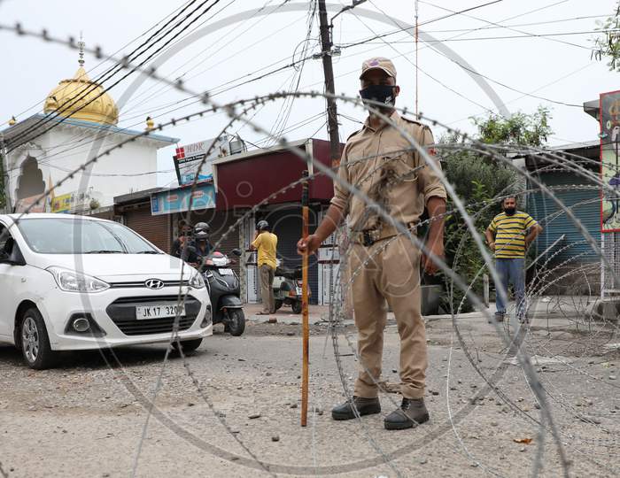 A police officer patrols a Covid Red Zone area in Talab Tillo, Jammu on July 16, 2020