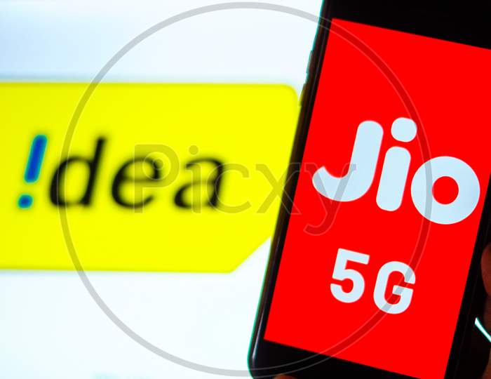 Close Up shot of a Mobilephone or Smartphone with Jio 5G on Screen and idea 4G Logo in the Background - A Concept of Jio 5G vs Idea 4G