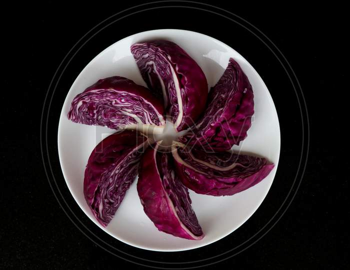 Fresh Raw And Organic Cut Violet Color Cabbage In White Plate As Texture, Background