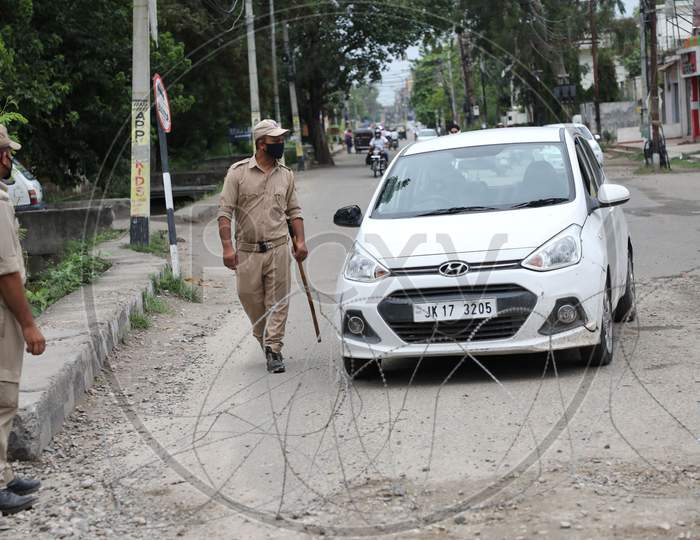 A police officer patrols a Covid Red Zone area in Talab Tillo, Jammu on July 16, 2020