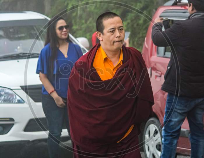 A Buddhist Monk Passing By The Road Towards Monastery