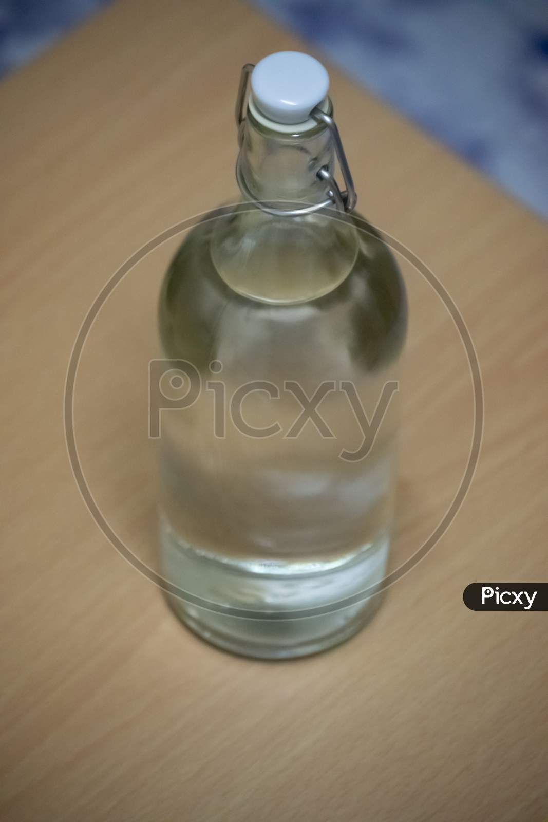 A Glass Bottle Filled With Water On A Table