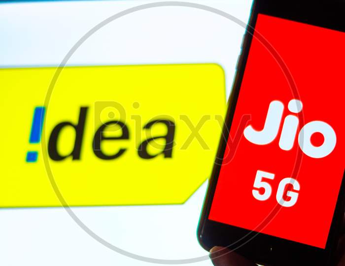 Close Up shot of a Mobilephone or Smartphone with Jio 5G on Screen and idea 4G Logo in the Background - A Concept of Jio 5G vs Idea 4G
