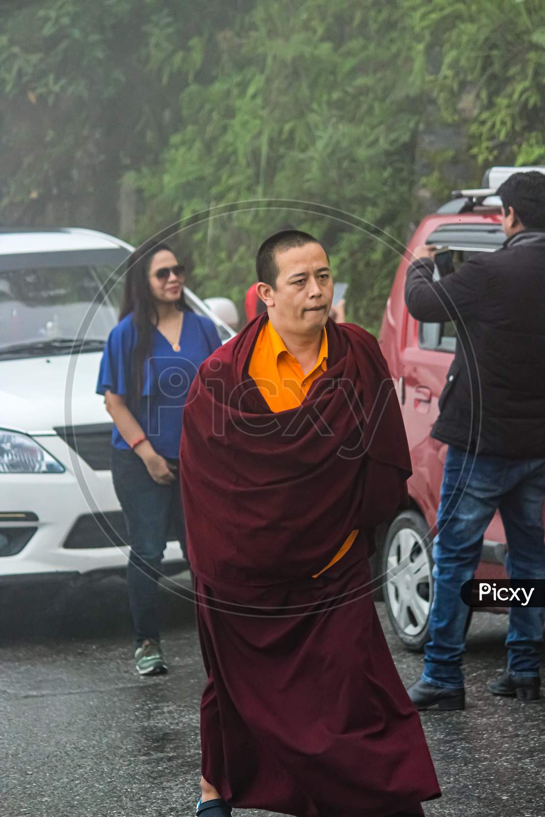 A Buddhist Monk Passing By The Road Towards Monastery